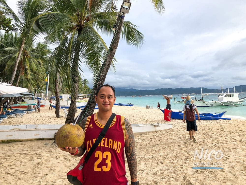 Holding a coconut on Boracay Beach